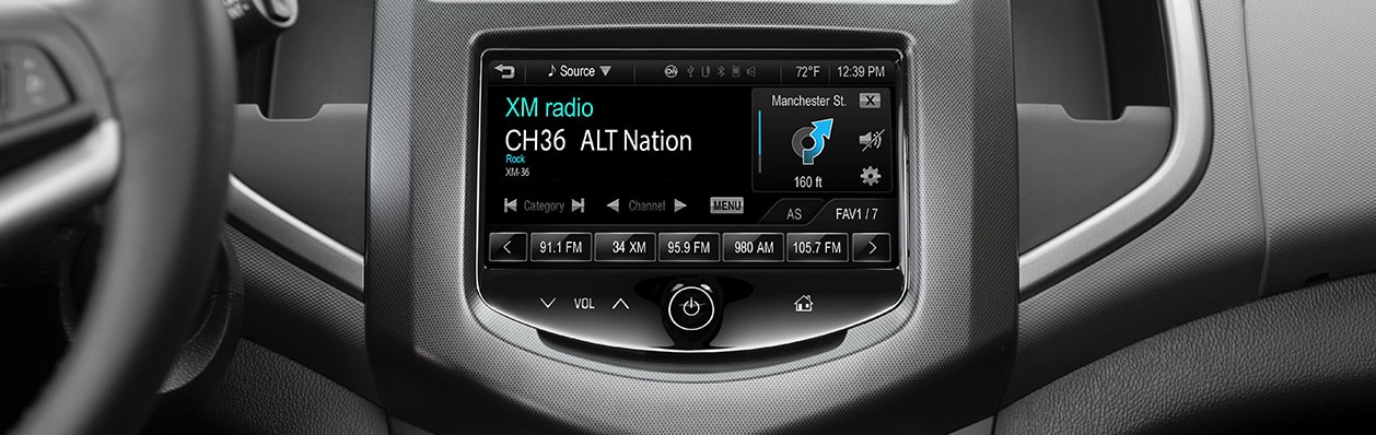 Close-up of a vehicle entertainment system playing a SiriusXM station